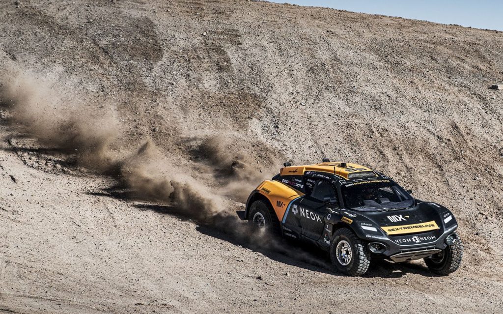 NEOM McLaren Extreme E car racing down dirt hill