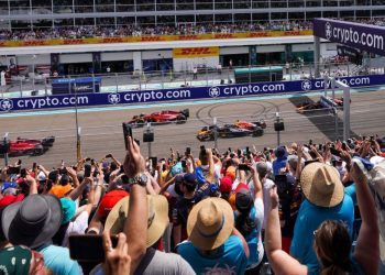 Formula 1 cars on race track in front of fans